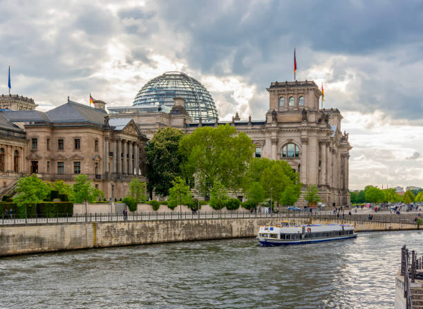 istock Reichstag building and Spree river at sunset, Berlin, Germany 1472313563