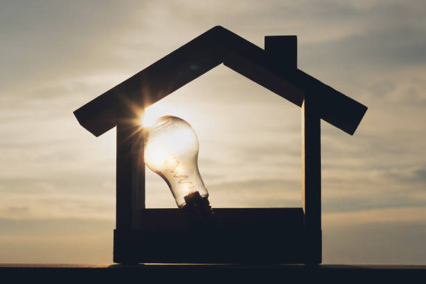 istock Light bulb with wood house on the table, a symbol for construction, Creative light bulb idea, power energy or business idea concept ecology, loan, mortgage, property or home. 1472314284
