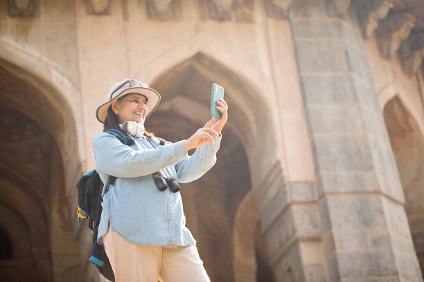 istock Old woman admiring view during vacation on a sunny day 1472314428