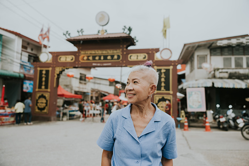 Thai senior hipster enjoy her retirement life with traveling at Chinese old town.