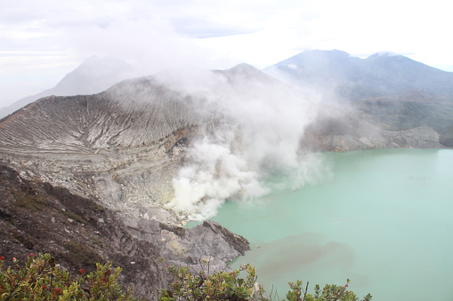 sulfur mining and Ijen crater in turquoise color, Mount Ijen
