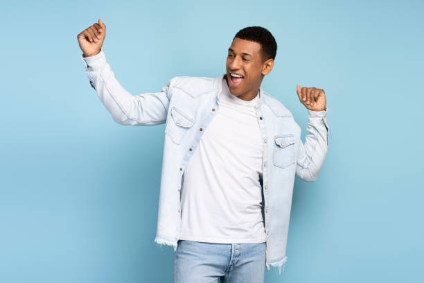 istock Energetic positive inspired brunette man dancing and rejoicing alone 1472317519