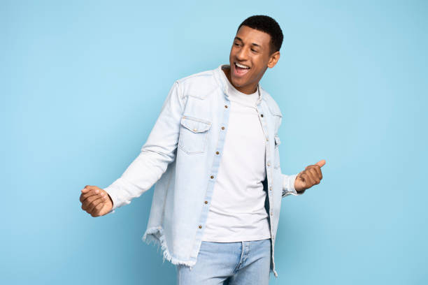istock Energetic positive inspired brunette man dancing and rejoicing alone 1472317538