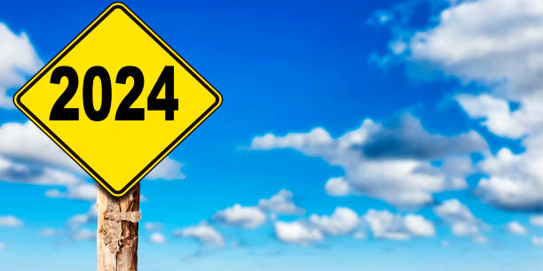istock 2024 new year concept ahead road sign with trunk tree, sky background 1472319941