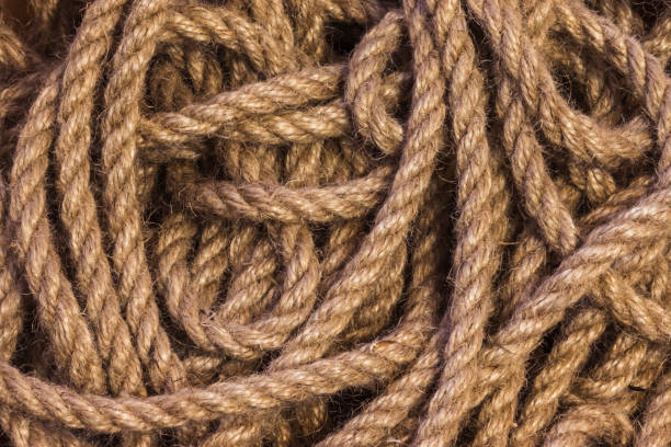 istock Abstract ropes, cables, hems background, Tangled rope rope background. Jute rope. Shot up close 1472323704
