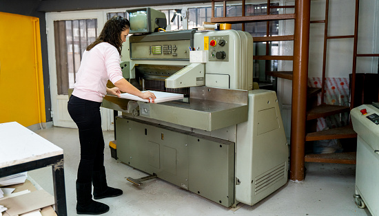 mature woman working in a cutting press