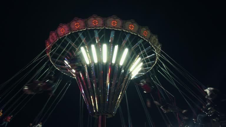 Illuminated chain carousel by night