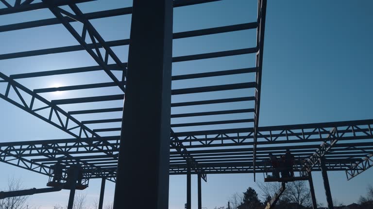 Steel worker operating cherry picker