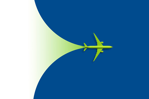 Green modern passenger plane against blue background