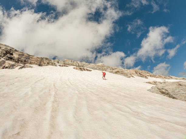 mountain climber moving up on snowy route - conquering adversity wilderness area aspirations achievement imagens e fotografias de stock