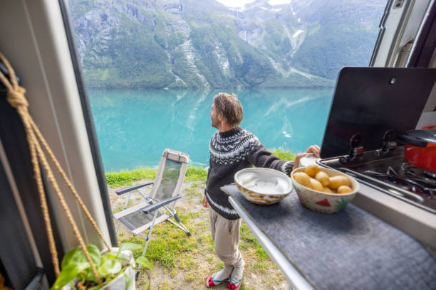 istock The van life, preparing diner by a beautiful lake on picnic table 1472333222