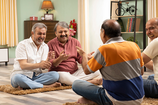 Senior friends discussing while sitting at home