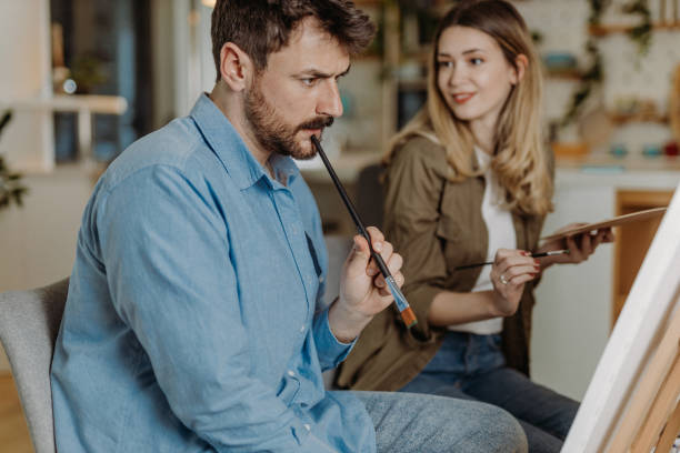 istock Young couple painting at home 1472339087