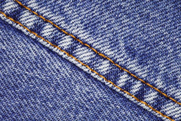 istock Denim dark blue and suture sewn with orange threads, close-up, background wallpaper, uniform texture pattern 1472339632