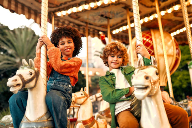 istock Kids having fun on a carnival Carousel 1472340387