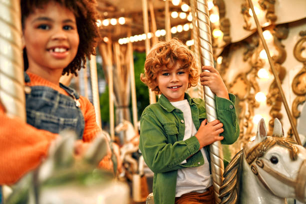 istock Kids having fun on a carnival Carousel 1472340395