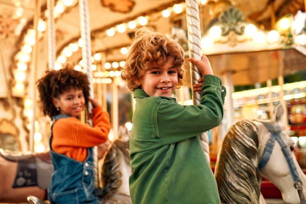 istock Kids having fun on a carnival Carousel 1472340413
