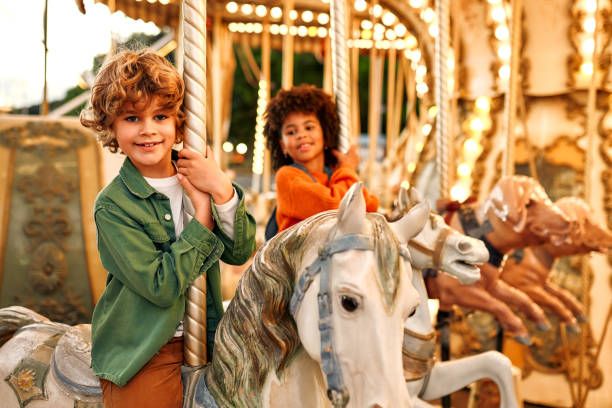 istock Kids having fun on a carnival Carousel 1472340424