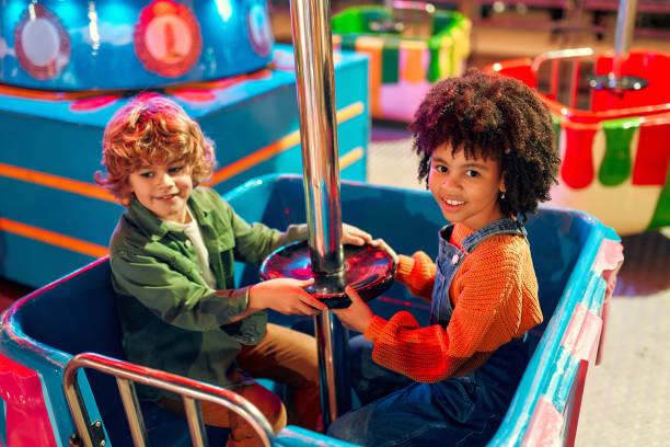 istock Kids having fun on a carnival Carousel 1472340460