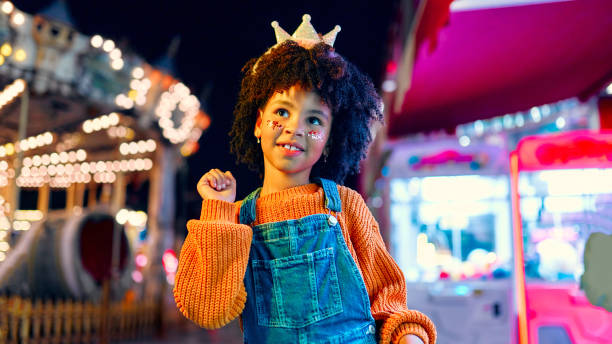 los niños se divierten en un carnaval de carrusel - carousel merry go round child african descent fotografías e imágenes de stock