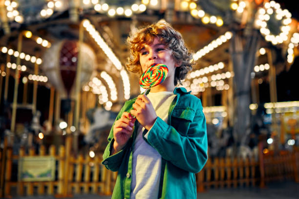 istock Kids having fun on a carnival Carousel 1472341724
