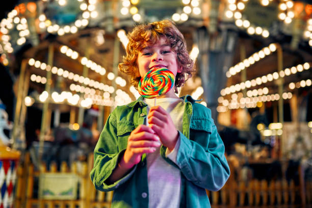 istock Kids having fun on a carnival Carousel 1472341725