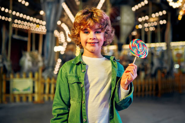 istock Kids having fun on a carnival Carousel 1472341726
