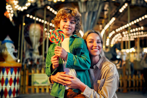 istock Kids having fun on a carnival Carousel 1472341736