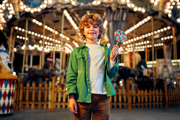 istock Kids having fun on a carnival Carousel 1472341738