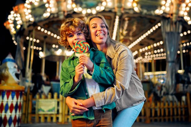istock Kids having fun on a carnival Carousel 1472341741