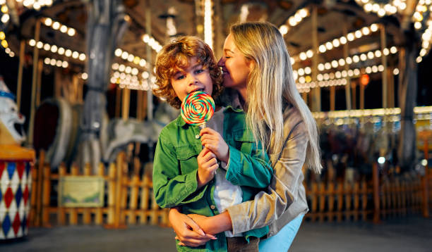 istock Kids having fun on a carnival Carousel 1472341747
