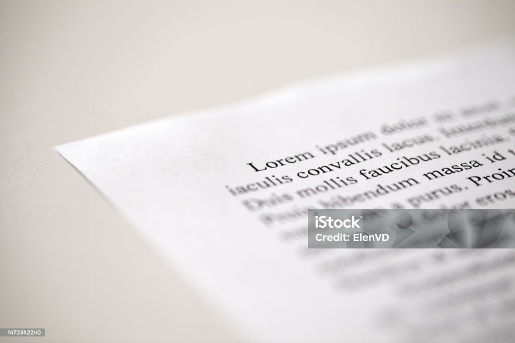 Lorem Ipsum text on printed on paper in black and white, sample of document, side view, selective focus Angle Stock Photo