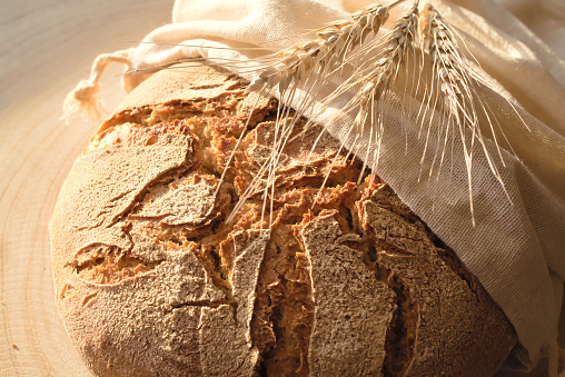 fresh rye bread on wooden background