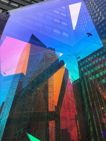 Abstract window reflections of buildings through an art installation in near Times Square Manhattan.