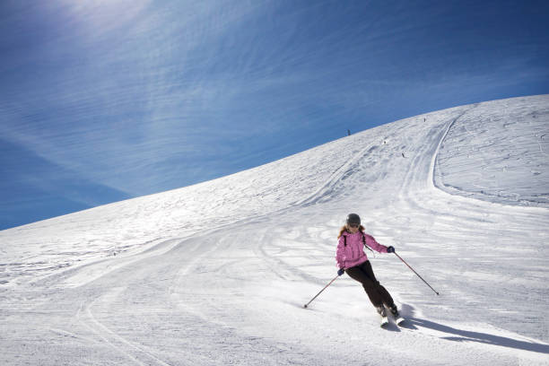 A woman decending a slope al Mammarosa ski resort, on the Majella range in Abruzzo, Italy.