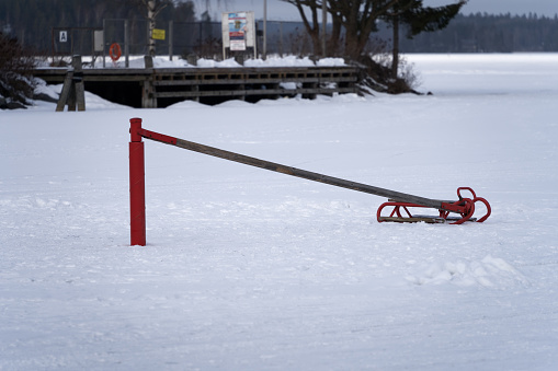 Traditional Finnish napakelkka (hoijakka) on a frozen lake. Sleigh connected to the central pole with a beam.