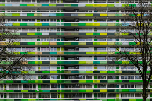 Big appartment building with balconys and yellow and green decorations