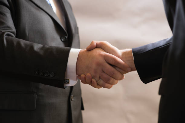 Business handshake of two businessmen in suits, negotiate and make a deal stock photo