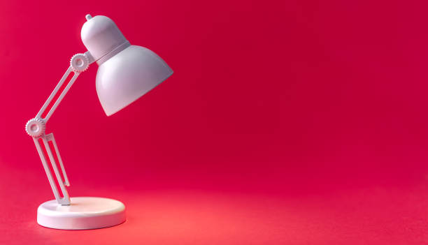 istock White table lamp on a Viva Magenta background, copy space. 1472352787
