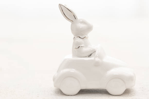 istock Decorative ceramic hare rides a car, close-up. 1472354514