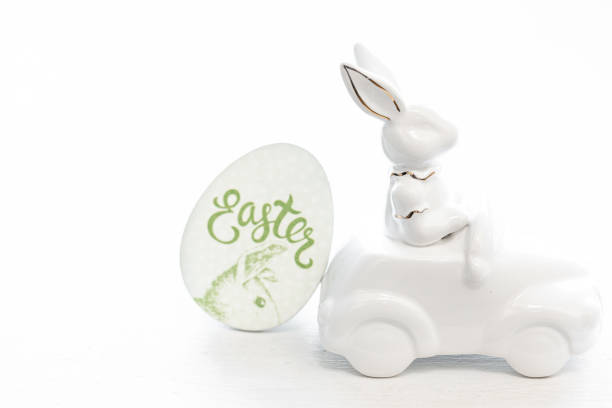 istock Easter background with a ceramic hare in the car. 1472354556