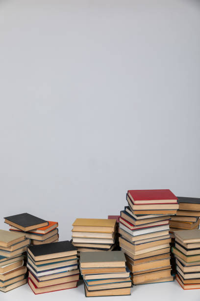 istock reading the science of knowledge many books stacked in a library on a white background 1472354637