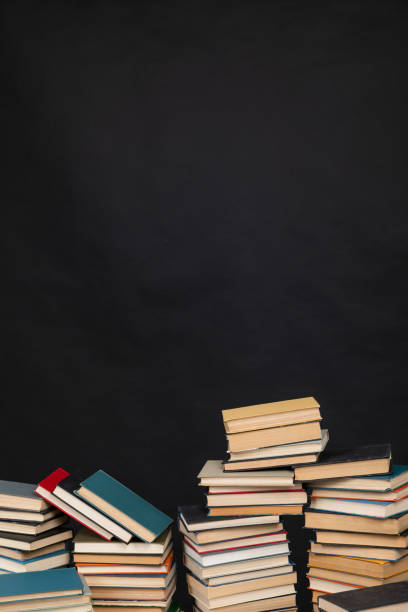 istock science knowledge reading many books in stacks in the library on a black background 1472355064