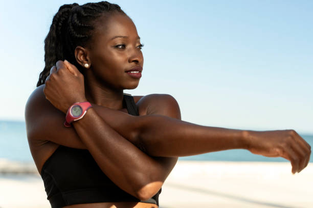 istock Young attractive multiracial woman in sportswear doing stretching hand before exercise 1472357241