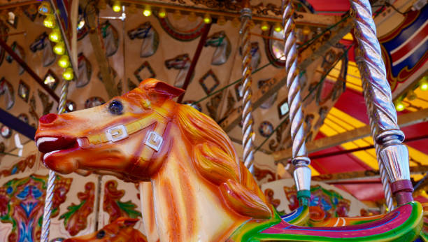 istock Close up faces of decorated horses on a fairground ride 1472357708
