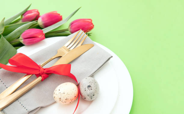 istock Easter table setting, Yellow Spring flowers, napkin and golden cutlery on white plates 1472359634
