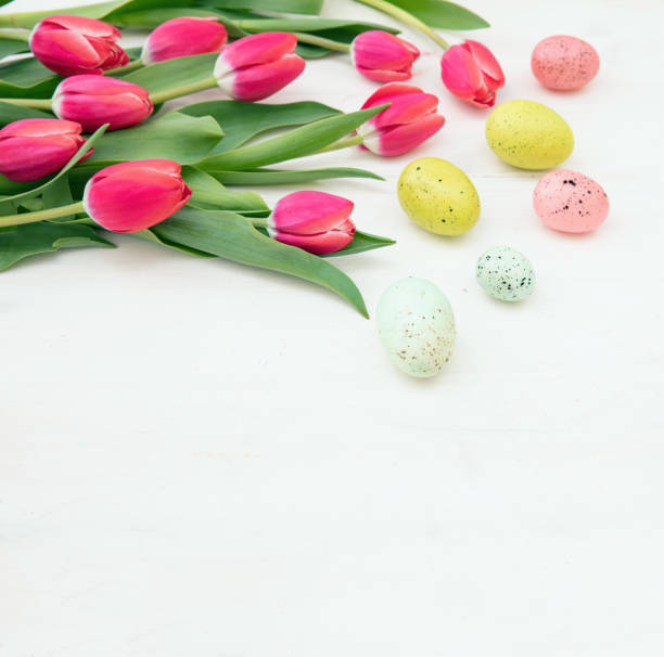 istock Happy Easter card template. Easter egg and tulips on white wood 1472359699