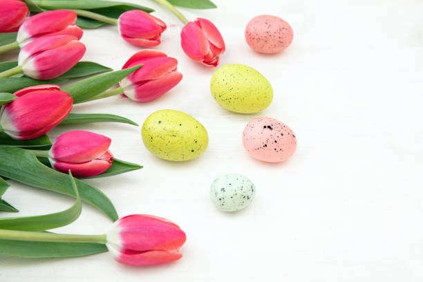 istock Happy Easter card template. Easter egg and tulips on white wood 1472359716