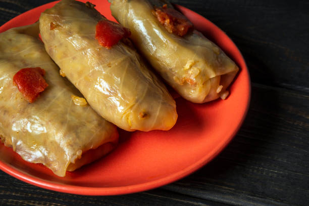 istock Cabbage rolls with beef, rice and vegetables on the plate. Stuffed cabbage leaves with meat. Black vintage table 1472360997