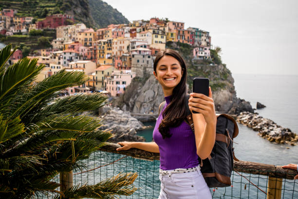 istock Latin tourist taking a selfie while visiting Italy 1472369120